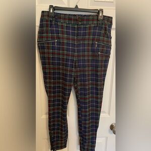 Plaid ponte skinny pants with button zip closure and zipper details.